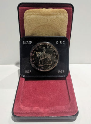 1973 SPECIMEN COMMEMORATIVE SILVER DOLLAR - ROYAL CANADIAN MOUNTED POLICE (TONED)